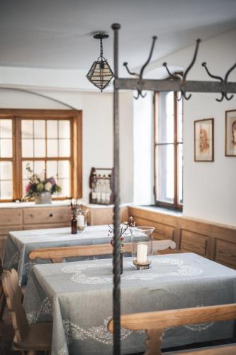 a dining room with two tables and a candle on it at Suiten Zantl in Bad Tölz