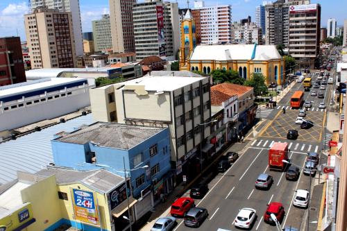 an overhead view of a city street with cars and buildings at Geneviee Palace Hotel in Ponta Grossa