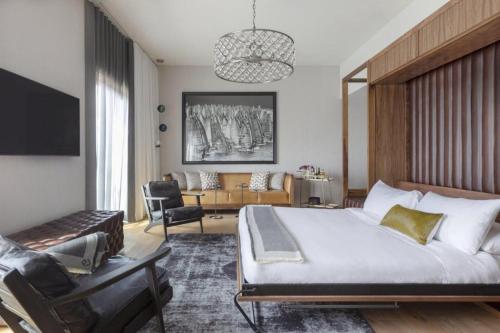a bedroom with a large bed and a living room at Park James in Menlo Park