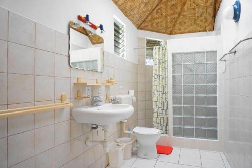 a bathroom with a sink and a toilet at Marcosas Cottages Resort in Basdiot