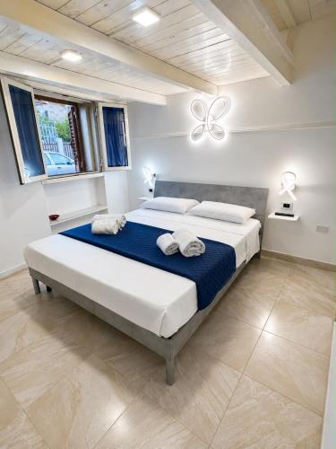 a bedroom with a large bed with towels on it at Core Salentino Rooms in Campomarino