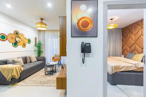 a living room with a couch and a bed at Nova, Sky Suites in Accra