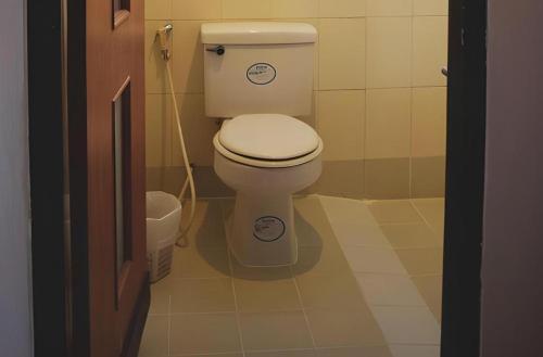 a bathroom with a white toilet in a room at EASTAN VIEW in Chiang Mai