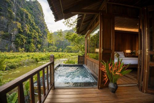 a room with a pool on a wooden deck at Karsia Retreat Ninh Binh in Ninh Binh