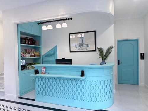 a shop with a blue counter in a room at Luangaloun Guesthouse in Luang Prabang