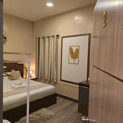 a hotel room with a bed and a bathroom at Victory place 2 (Golden Mount) in Bangkok