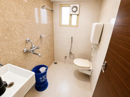 a bathroom with a toilet and a sink at TRPOTELS Formerly Hotel Sagar in Gwalior