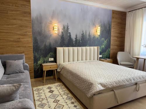 a bedroom with a bed and a painting on the wall at Bukovets' in Yaremche