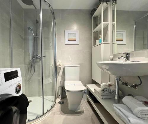 a bathroom with a shower and a toilet and a sink at Apartamentos Benal Beach Group in Benalmádena
