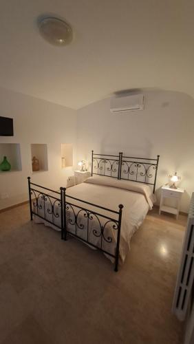 a bedroom with a bed with a metal frame at Agriturismo Zizzi in Ceglie Messapica