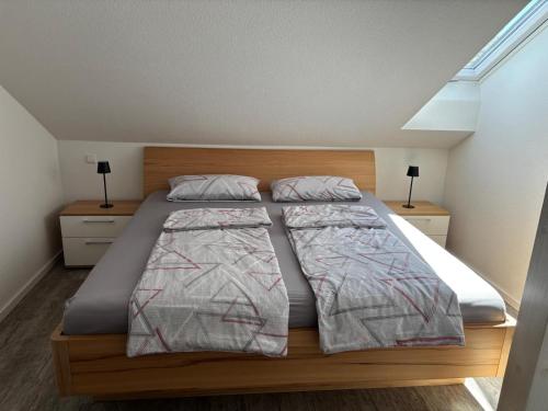 a bedroom with a large bed with two pillows at Ferienwohnung Roller in Endingen