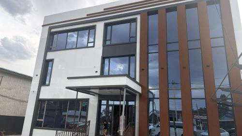 a building with large glass windows on it at Meridian Hotel in Georgīevka