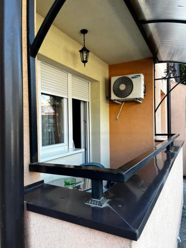 a glass counter in a room with a window at Apartman Milkovic 2 in Sombor