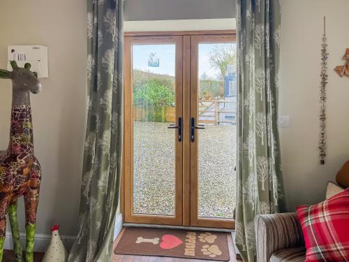 a sliding glass door with a view of a yard at Maggie's Place in Holsworthy