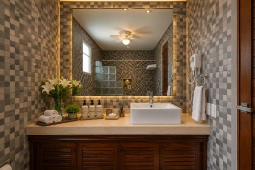a bathroom with a sink and a mirror at Casa Seven Ocean Front with Private C hef Included in Isla Mujeres