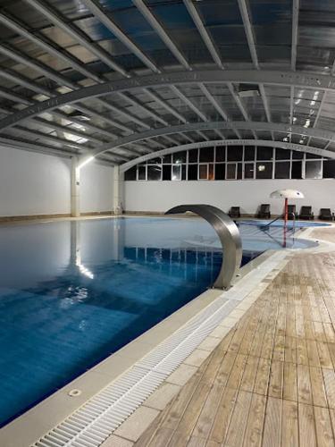 a large swimming pool in a large building at Yalçın Resort Hotel in Korgan