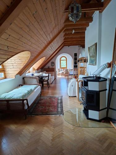a living room with a bed and a stove in it at Johannesburg in Révfülöp