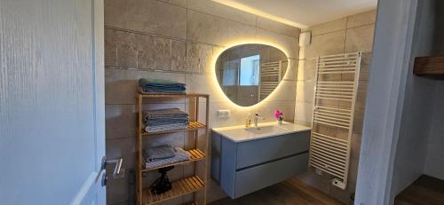 a bathroom with a sink and a mirror at Maison d' Adèlbraz in Voulaines