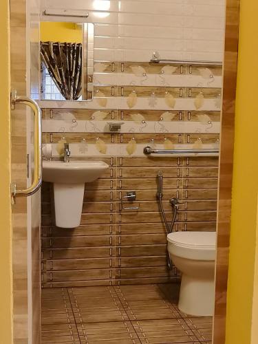 a bathroom with a sink and a toilet at Clintons Cove in Cochin