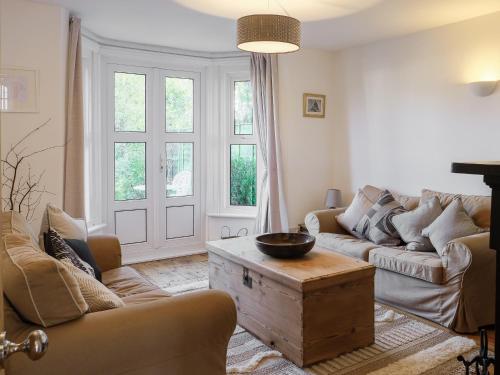 a living room with a couch and a table at Loreto in Freshwater