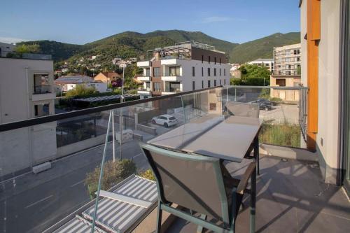 a balcony with a table and a view of a city at Elefante 10 - Donja Lastva in Donja Lastva
