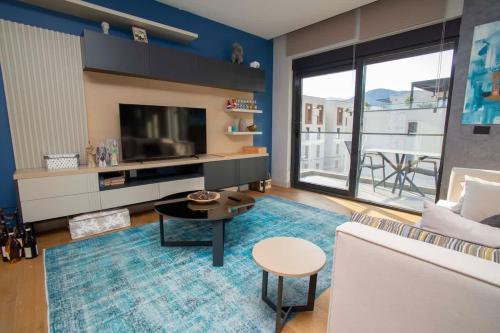 a living room with a couch and a tv at Elefante 10 - Donja Lastva in Donja Lastva