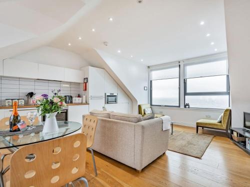 a kitchen and living room with a table and a couch at Killantrae Burn in Port William