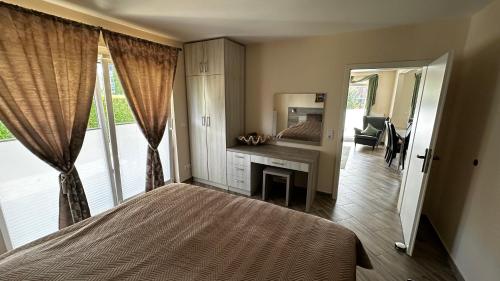 a bedroom with a bed and a desk and a mirror at SONNENSEITE 2 in Laboe
