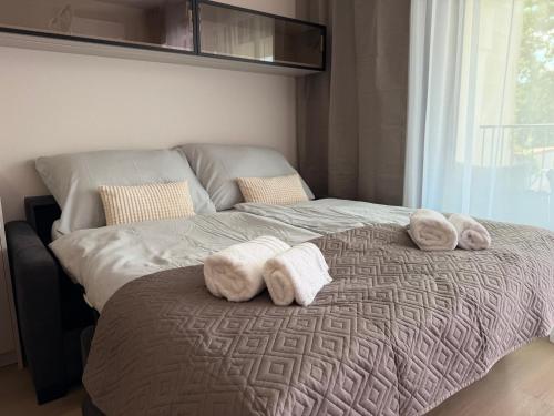 a bedroom with a bed with towels on it at MOOD Apartment Piešťany Centrum, parking, terasa in Piešťany