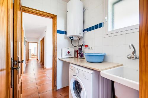 a kitchen with a washing machine and a sink at Villa Casa Nova by 3VILLAS in Sant Lluis