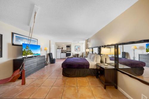 a hotel room with a bed and a television at RoofTop Resort - Hollywood Beach, Florida in Hollywood
