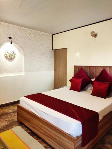 a bedroom with a large bed with red pillows at Mysa Maya Homestay 12Mins Walk to Mall Road in Darjeeling