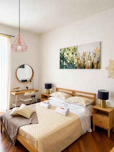 a bedroom with two beds and a mirror at iDream Apartment & Rooms in Catania
