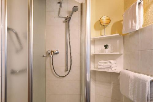 a shower with a glass door in a bathroom at Hirschsprung in Breitnau
