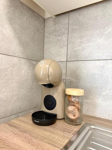 a coffee maker sitting on a counter next to a jar at Apartments Antini in Solin
