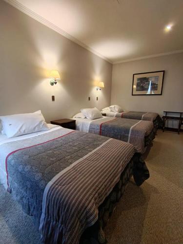 a hotel room with two beds in a room at Hotel Isla Rey Jorge in Punta Arenas