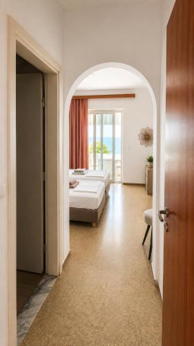 a hotel room with a bed and a window at Antonios Apartments Stegna in Archangelos