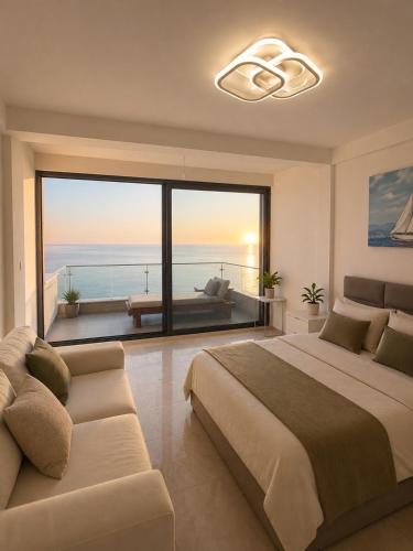a bedroom with a bed and a view of the ocean at Vila Maxim in Marovići