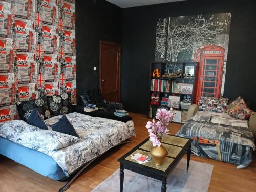 a living room with a couch and a table at Tosmare Apartament in Liepāja
