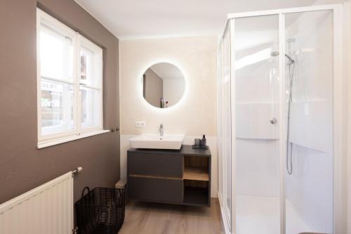 a bathroom with a sink and a shower at Familienparadies - Chalet Hoamatl in Achenkirch