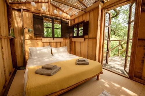 a bedroom with a bed with two towels on it at Novanta90 Tuscan Village Retreat in Bibbiena