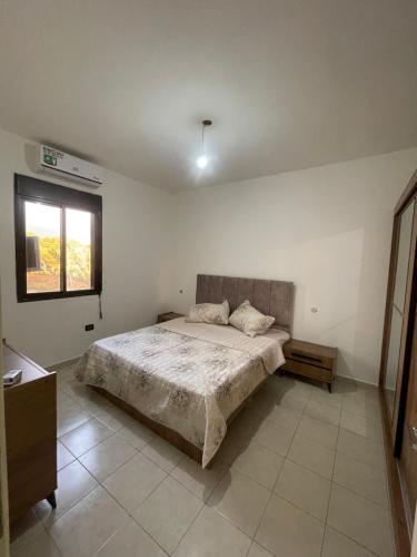 a bedroom with a bed and a window at Haidar house in Baabda