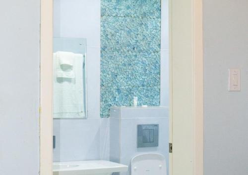 a bathroom with a white toilet and a mirror at Hotel Medallion in Lagos