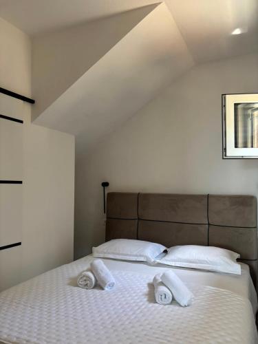 a bedroom with a bed with two towels on it at Apartman NoTi in Milna