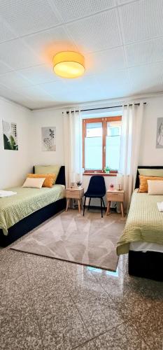 a large room with two beds and a window at GADD Ferienwohnung 004 Glück an der Donau I Best Prestige Stay 24 h Check-In in Straubing