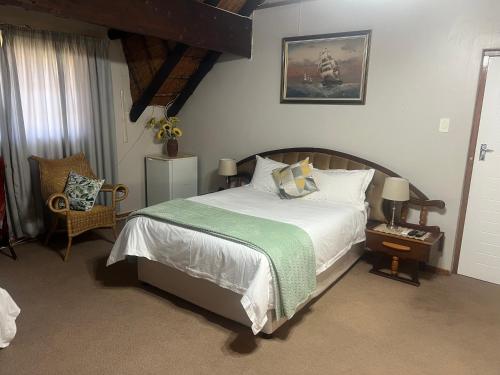 a bedroom with a bed with a green blanket at Serendipity Guest House in Richards Bay