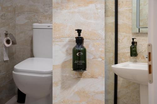 two pictures of a bathroom with a toilet and a sink at N'Log N'Skuraj Hotel in Ferr -Skuraj