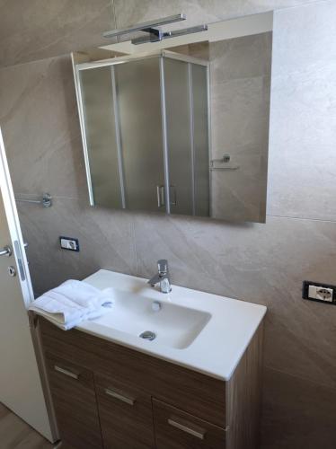 a bathroom with a sink and a mirror at Residence Mancini - Cilento Home & Sunset in Rocca Cilento