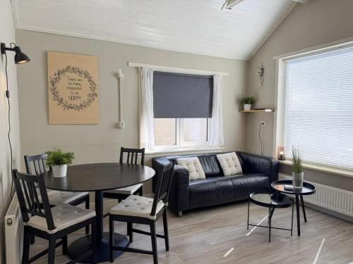 a living room with a table and a couch at Texelheerlijk 1 in De Koog