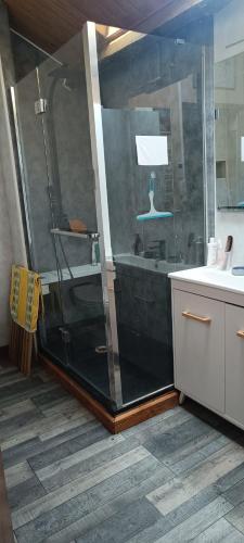 a bathroom with a shower with a lamp on it at Domaine de Béchegut in Marval